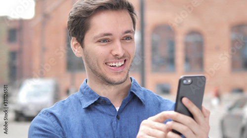 Happy Young Man Using Smartphone, Outdoor