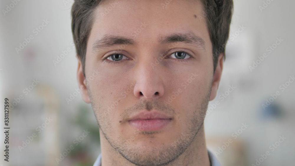 Obraz premium Face Close Up of Serious Handsome Young Man