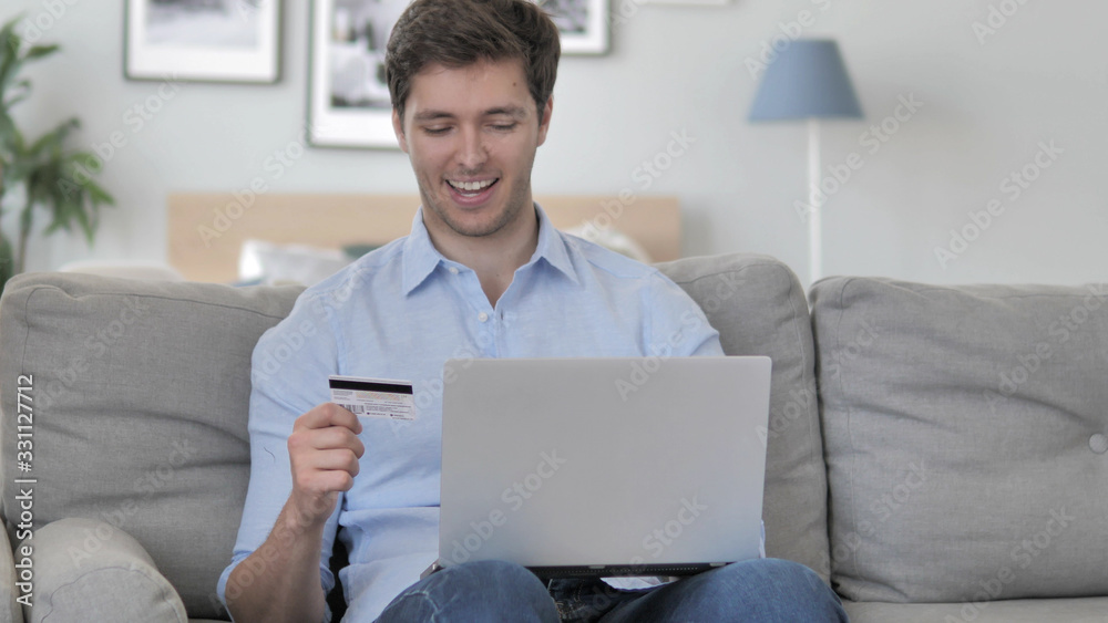 Excited Man Successfully Shopping Online with Credit Card Excited Man Successfully Shopping Online with Credit Card