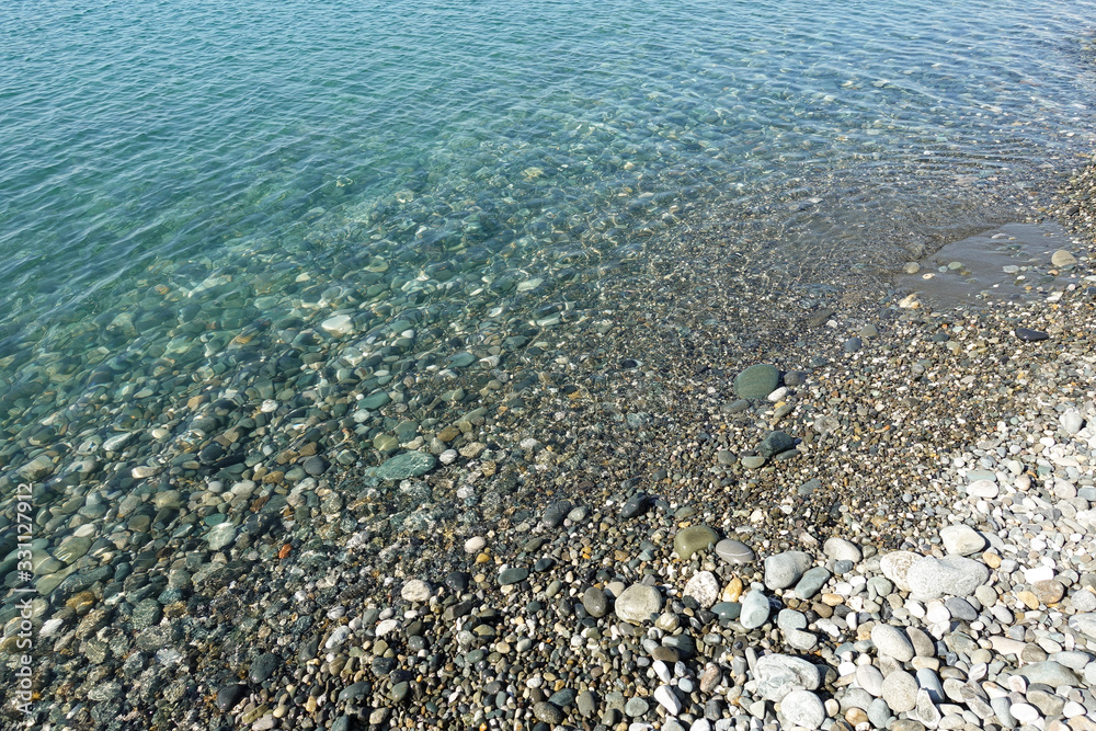 Sea stones in the sea water. Pebbles under water. The view from the top. Nautical background. Clean sea water. Transparent sea. Sea stones in the sea water. Pebbles under water. The view from the top. Nautical background. Clean sea water. Transparent sea.