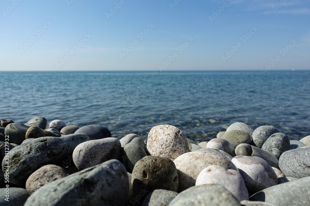 Sea view. Pebble beach with large stones Sea view. Pebble beach with large stones