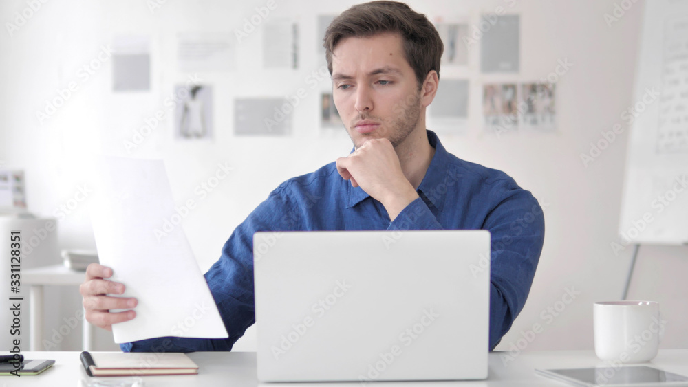 Casual Adult Man Reading Documents at work Casual Adult Man Reading Documents at work