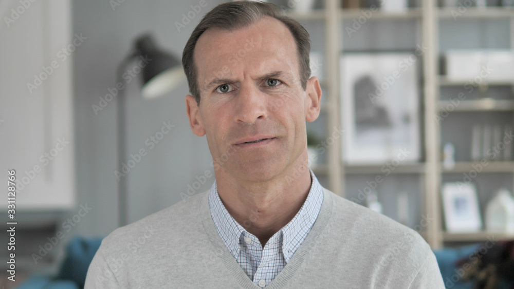 Naklejka premium Portrait of Sad Middle Aged Man Looking at Camera