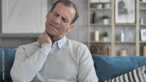 Middle Aged Man Trying to Relaxing Neck Pain at Home