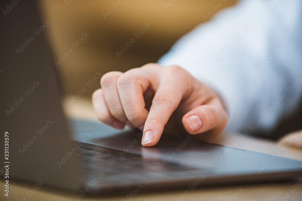 woman hand on laptop touchpad close up woman hand on laptop touchpad close up