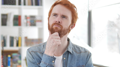 Obraz na plátně Portrait of Thinking Young Casual Redhead Man