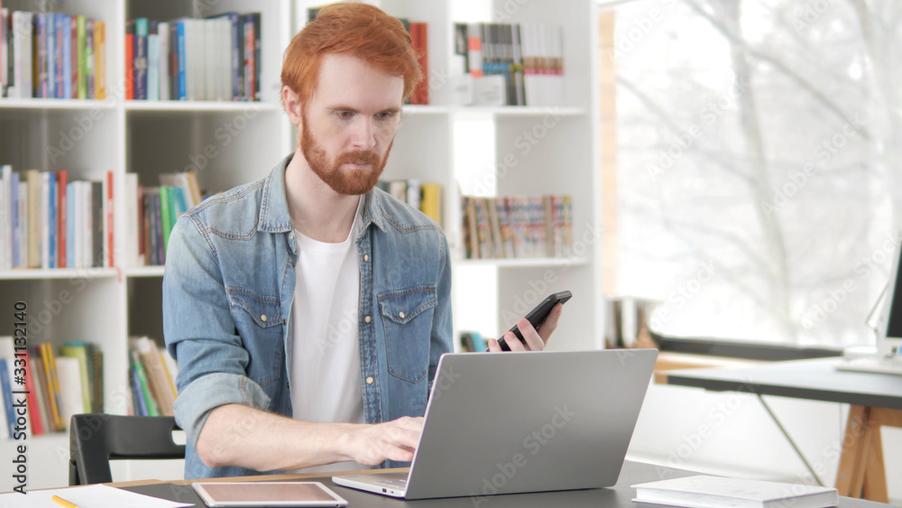 Multitasking, Young Casual Redhead Man Using Phone, Tablet and Laptop
