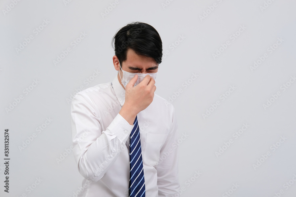 businessman man feeling sick, sneezing coughing wearing protective mask against cold flu virus bacteria infection pollution businessman man feeling sick, sneezing coughing wearing protective mask against cold flu virus bacteria infection pollution