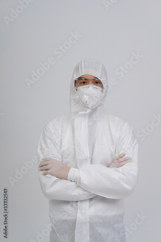 man doctor wearing protective uniform suit clothing, mask, gloves for preventing virus bacteria infection contamination