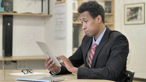 Young African Businessman Browsing on Tablet