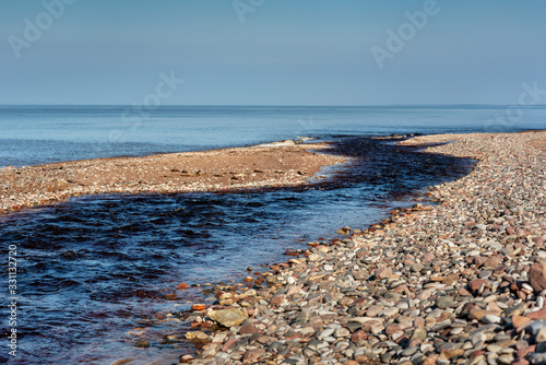 Fototapeta Naklejka Na Ścianę i Meble -  Small river flowing to the Baltic sea.