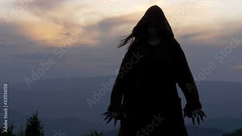 Epic fantasy scene of sorcerer standing on top of the hill