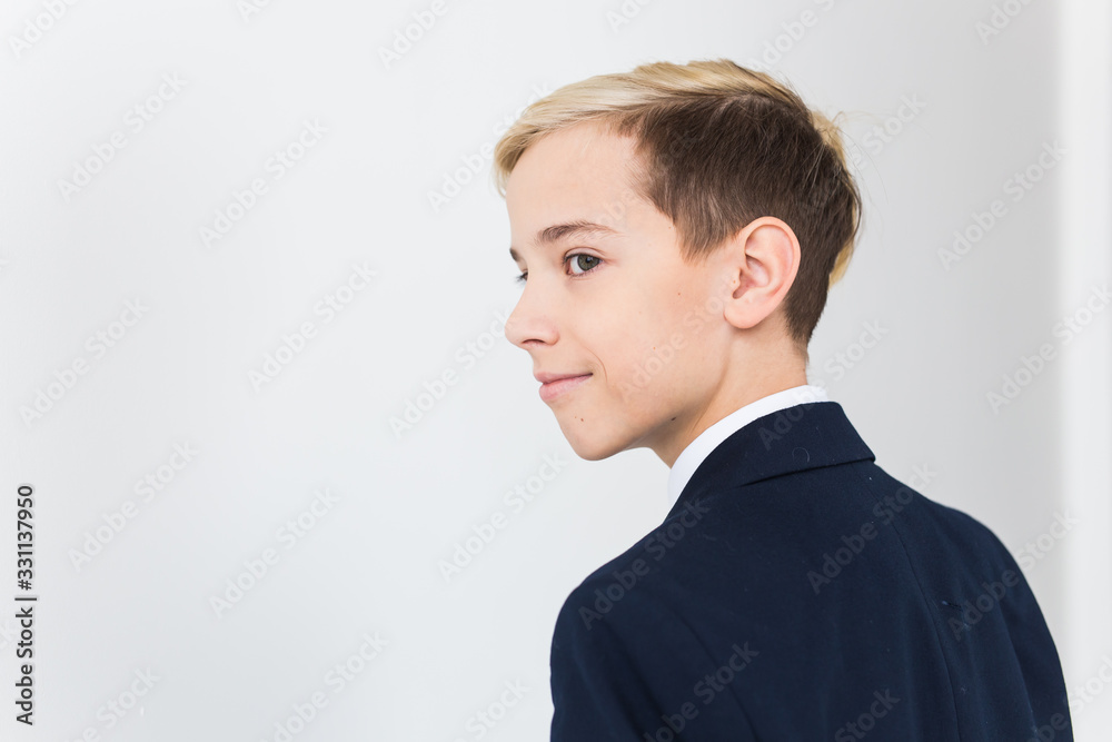 Portrait of stylish school boy teenager in white shirt and jacket against white background with copy space. Portrait of stylish school boy teenager in white shirt and jacket against white background with copy space.