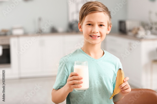 Little boy with milk and ba...