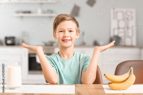 Little boy with milk and ba...