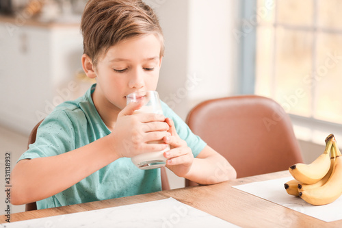 Little boy drinking milk in...