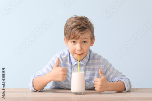 Little boy with milk showin...