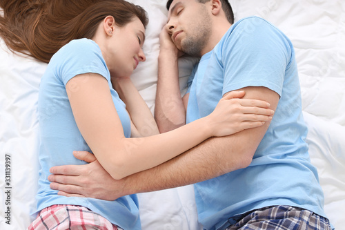 Young couple sleeping in bed