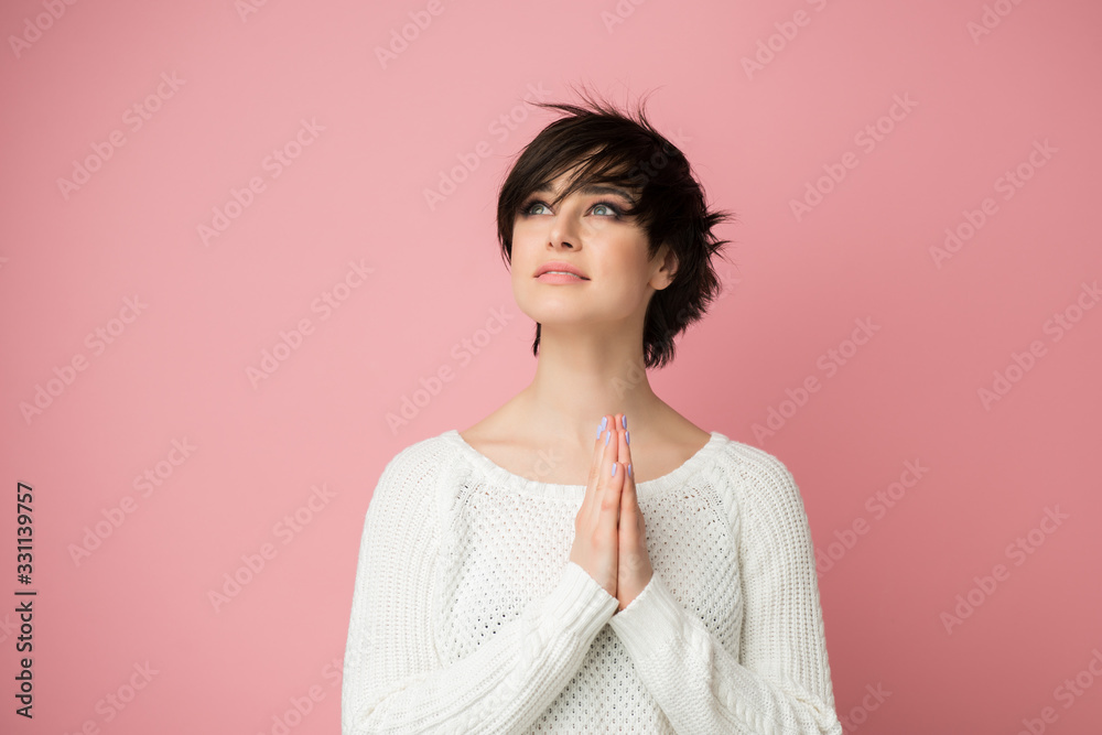 Young pretty woman praing with hands on chest and grateful gesture on face. Pretty woman feels grateful, hope, success. Plea, thanks and wishes Young pretty woman praing with hands on chest and grateful gesture on face. Pretty woman feels grateful, hope, success. Plea, thanks and wishes