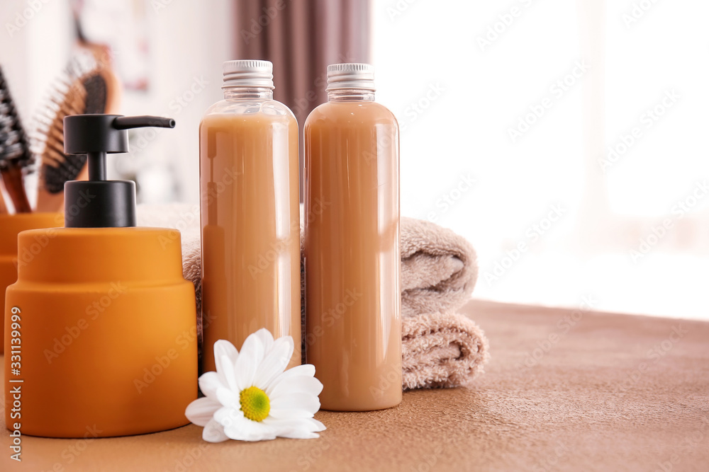 Shampoo and towels on table