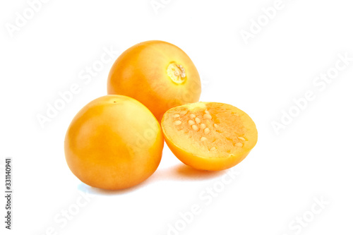 Goldenberries  Physalis peruviana ripe fruit  half and whole smooth berries isolated on a white background