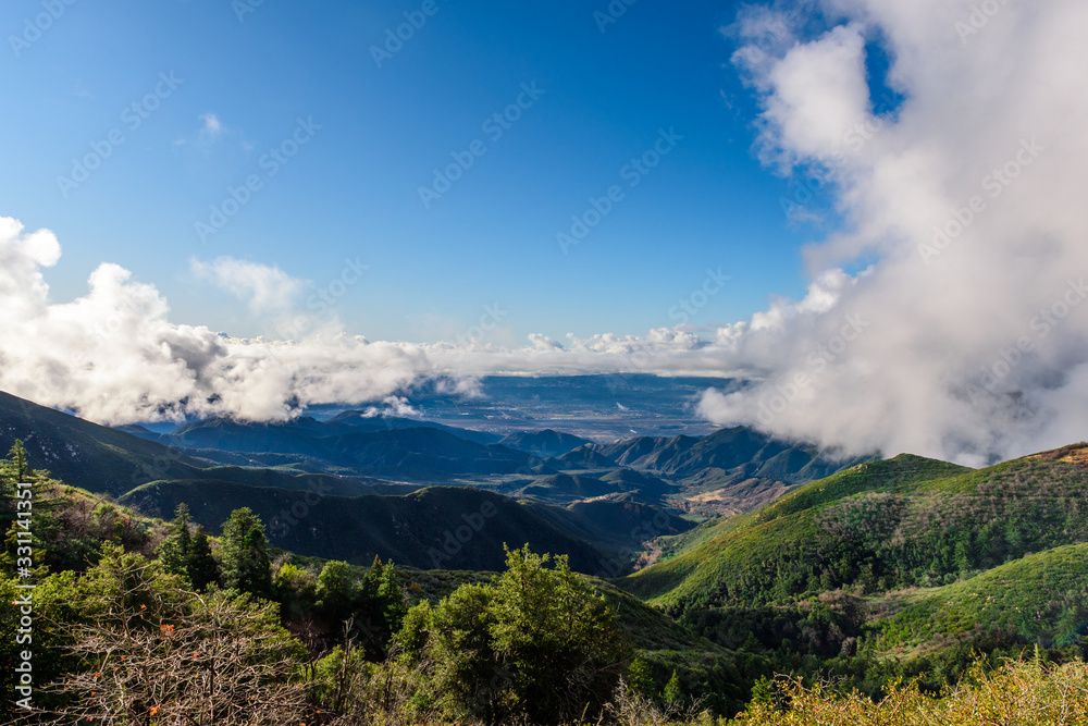 Breathtaking mountain view scenery with foggy clouds and blue sky