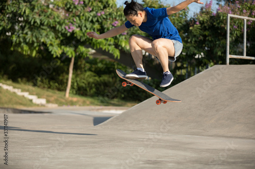 Woman skateboarder skating at skatepark