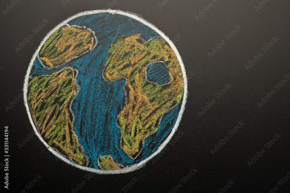 Planet earth is drawn by children on the blackboard with chalk, save the planet, global warming, environmental pollution