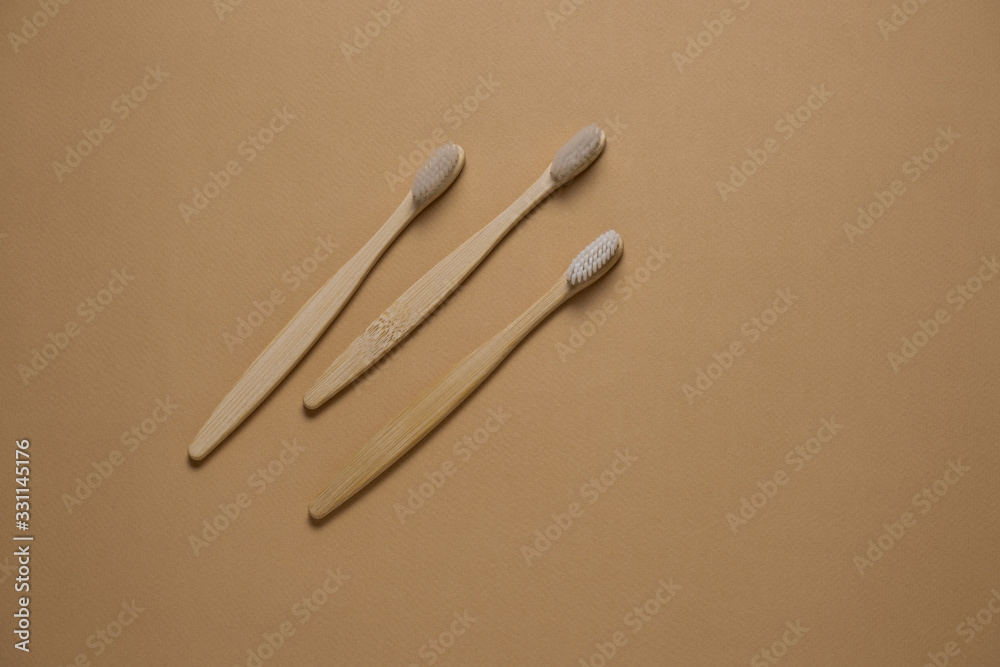 top view bamboo eco friendly tooth brushes on a beige background copy space top view bamboo eco friendly tooth brushes on a beige background copy space