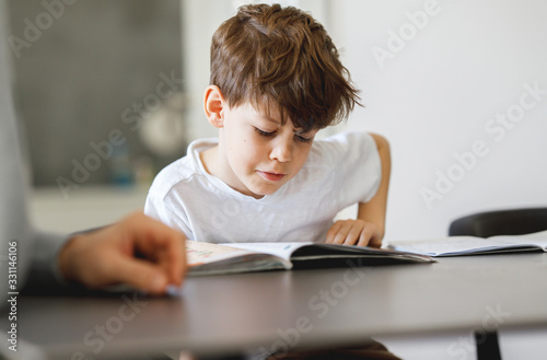 Portrait of schoolboy reading a Book