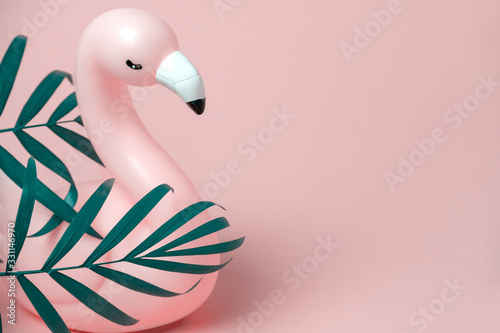 pink flamingo and palm leaves frame pink background copy space