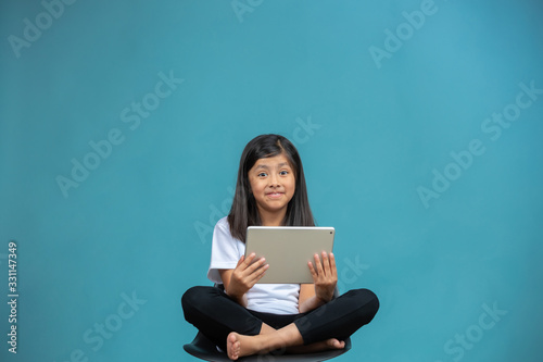 little girl smiling with tablet