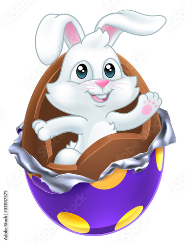 The Easter bunny rabbit breaking out of a chocolate egg
