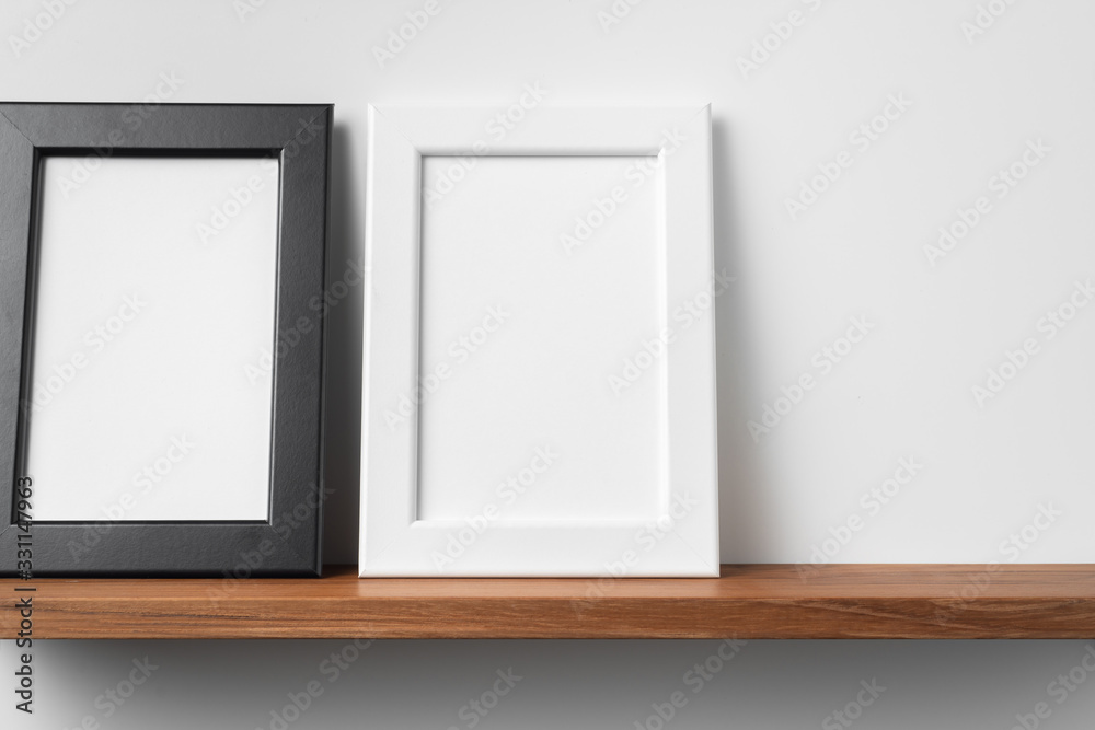 vertical wood photo on bookshelf and wall