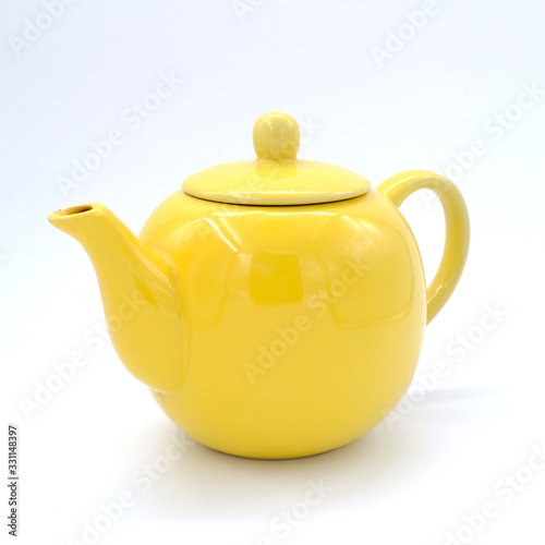 Yellow teapot isolated on white background