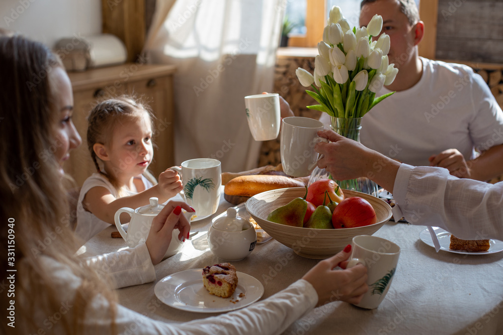 horizontal close-up photo of a family of four who enjoy breakfast together horizontal close-up photo of a family of four who enjoy breakfast together