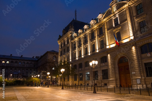 Place Louis Lépine, Paris, France, November 2019. Beautiful shot of the square, the Paris Police Prefecture (Préfecture de police de Paris). Typical street lamps. Paris by night.