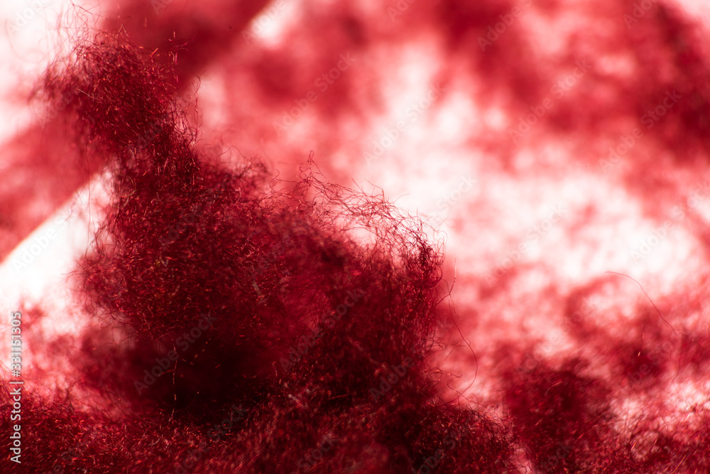Abstract red background with tuft of wool