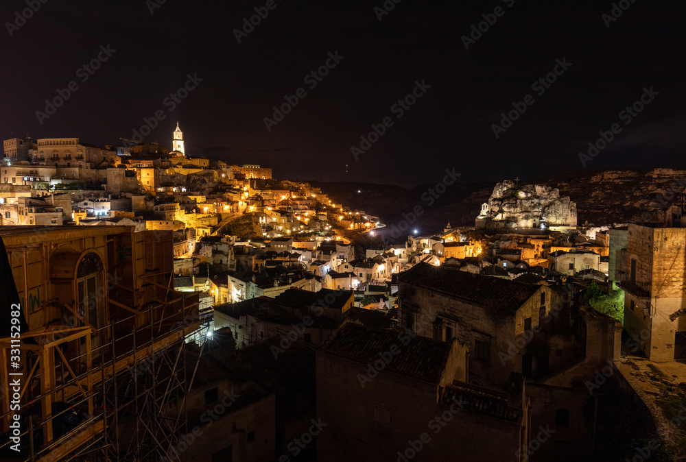 Naklejka premium Night landscape of the Sassi of Matera, well-known for their ancient cave dwellings. Basilicata. Italy