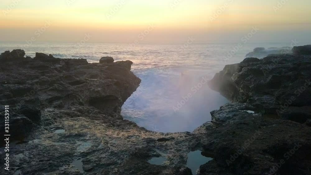 Shot of the beautiful great waves at Devil's Tear on Nusa Lembongan at sunset, in Bali, Indonesia Shot of the beautiful great waves at Devil's Tear on Nusa Lembongan at sunset, in Bali, Indonesia