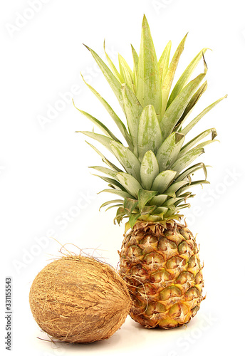 Ripe pineapple and coconut close-up isolated on a white background photo
