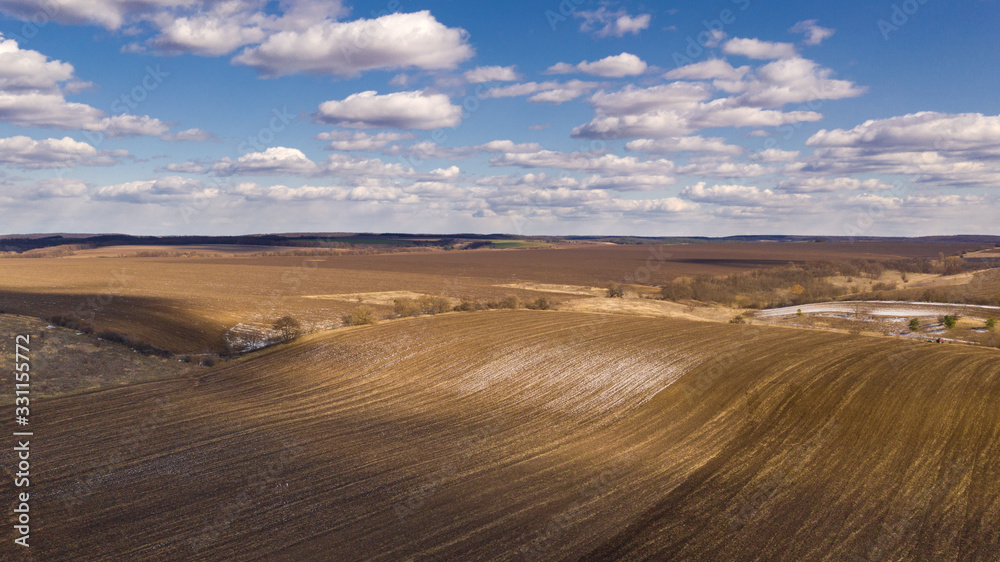 Drone shot of Ukrainian spring field. Natural background on a sunny day.
