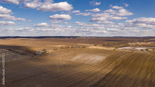 Drone shot of Ukrainian spring field. Natural background on a sunny day.