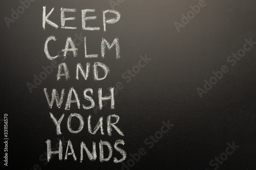 Chalk inscription on the blackboard - keep calm and wash your hands. Coronavirus and danger of getting sick. With space for inscription