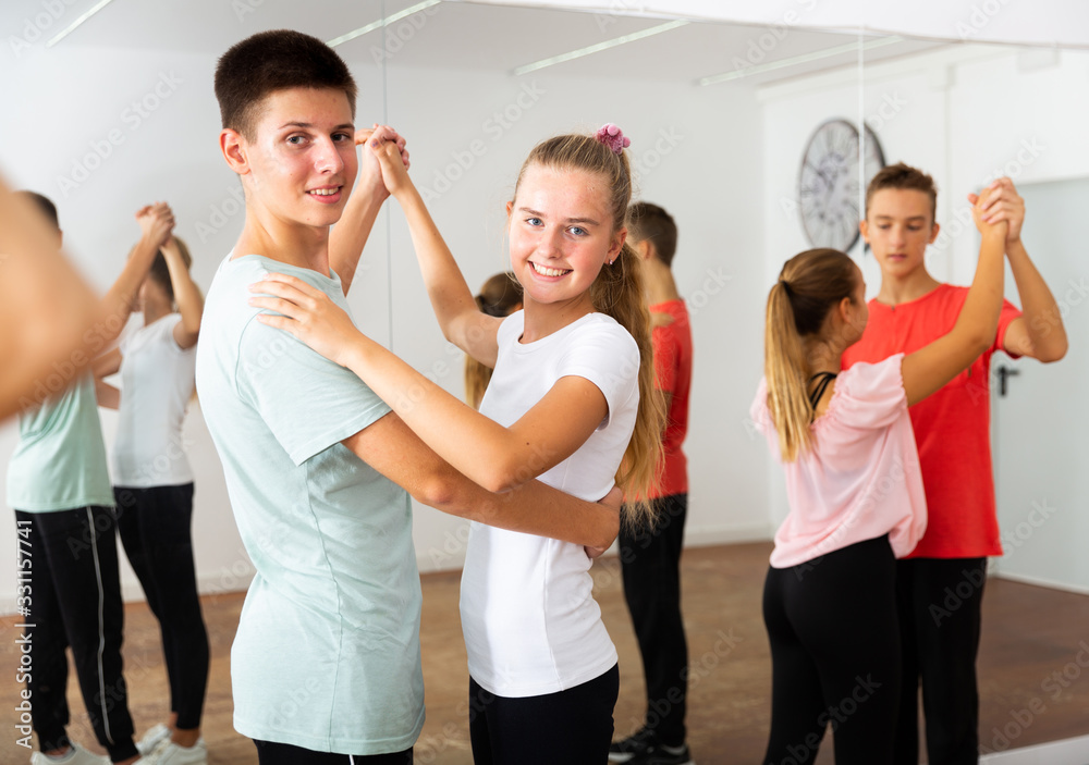 Teenagers dancing in pairs in choreography class