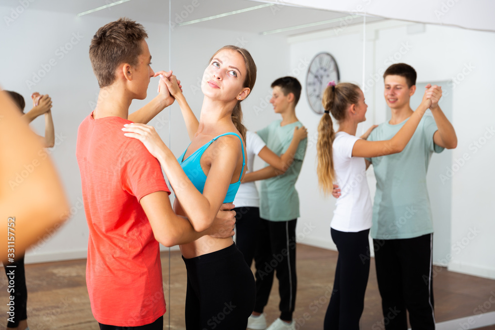 Teenagers dancing in pairs in choreography class