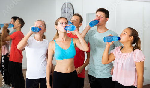 Teenagers drinking water in choreography class
