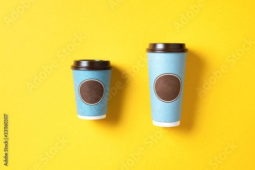 Take away tea or coffee cup on grey background. Top view. Copy space. Minimal composition, layout for design. Coffee concept