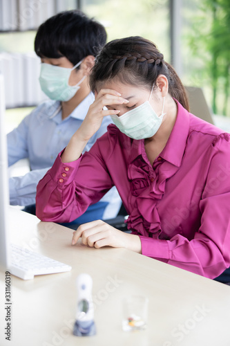 Woman feel headache in office.