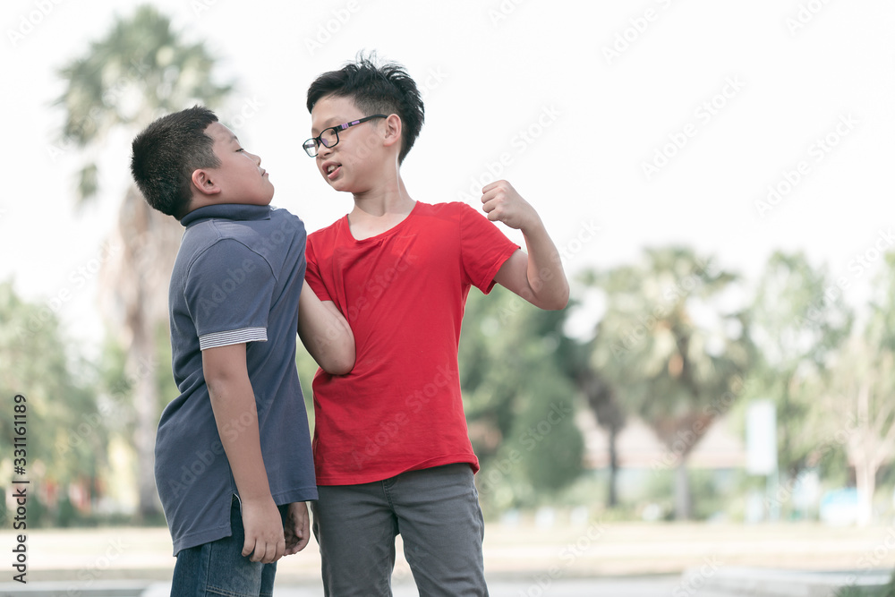 Asian Boy student getting bullied in school. Children bullying their classmate in playground